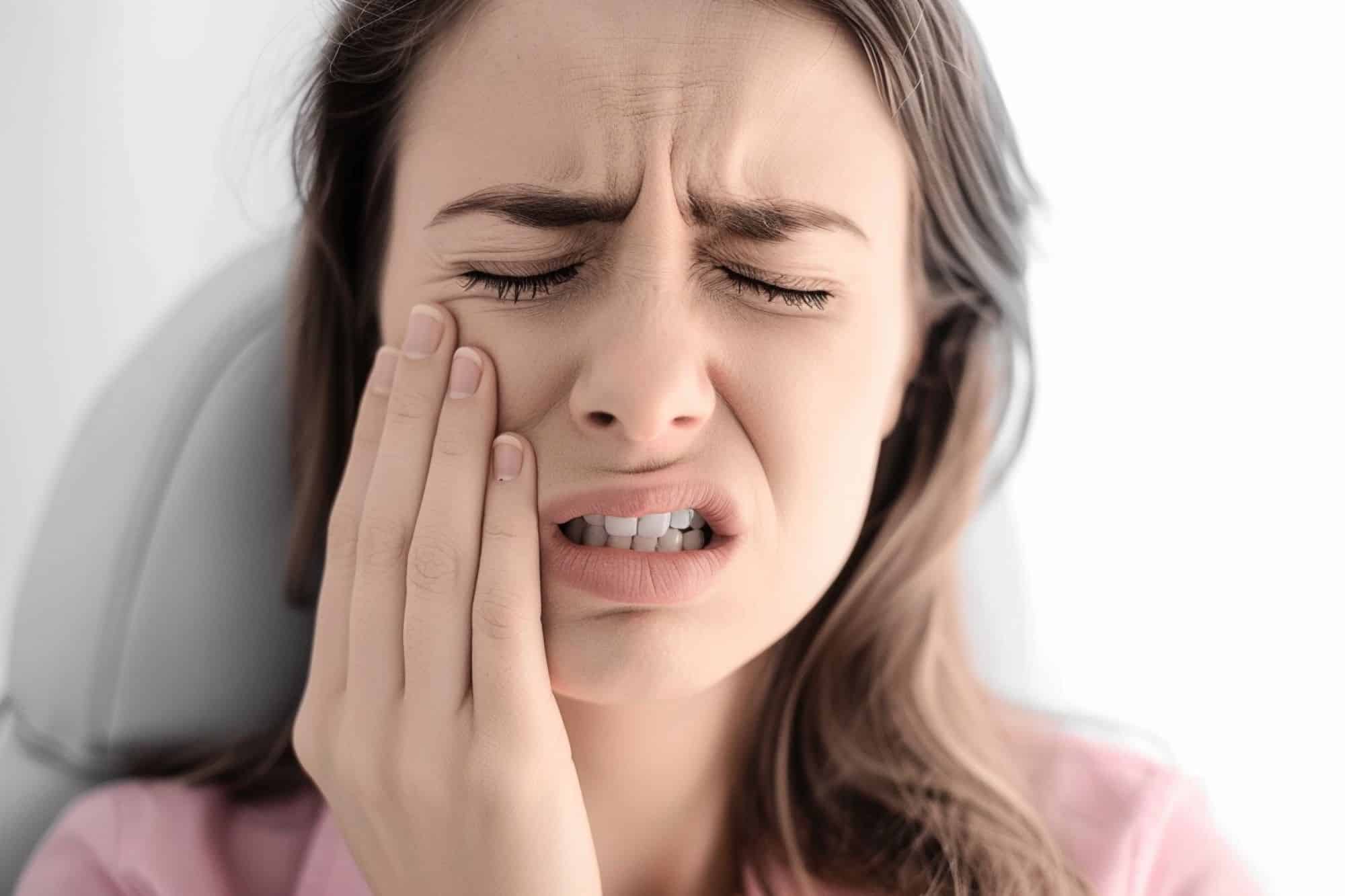 a woman suffering from tooth pain